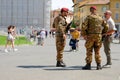 Pisa, Italy - June 8, 2022: Soldiers in camoflage talk to a man in the plaza in Pisa, Italy