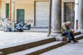 A wasted drunk man dozing on the street