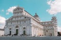 Pisa, Italy - March 18, 2023: Back view of travel tourists man making photo in front of leaning tower Pisa, Italy. Royalty Free Stock Photo