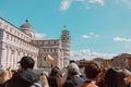 Pisa, Italy - March 18, 2023: Tourists packing the cathedral of Santa Maria Assunta and leaning tower in Piazza dei