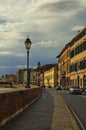 Scenic landscape view of medieval Italian architecture in Pisa. Colorful vintage buildings along embankment of Arno river
