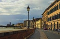 Scenic landscape view of medieval Italian architecture in Pisa. Colorful vintage buildings along embankment of Arno river