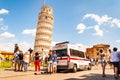 The famous leaning Tower of Pisa or La Torre di Pisa at the Cathedral Square, Piazza del Duomo full of tourists and ambulance on Royalty Free Stock Photo