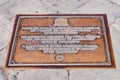 The Unesco metal floor tile plate says that Cathedral Square in Pisa with all the monuments inside is a World Heritage Royalty Free Stock Photo