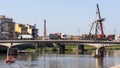 Workmen lifting a dead tree from the Arno river at Pisa Liguria Italy on April 18, 2019.