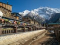 Pisang village prayer wheel alley with Annapurna mountain background Royalty Free Stock Photo