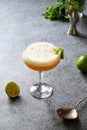 Pisco sour cocktail - whiskey with lime, egg white, syrup in glass on grey table. Vertical shot Royalty Free Stock Photo
