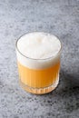 Pisco sour cocktail. Whiskey with lime, egg white, syrup in glass on grey. Vertical shot Royalty Free Stock Photo