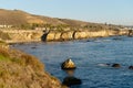 Pismo Beach cliffs and silhouettes of hotels overlooking the water\'s ege. Pismo Beach California