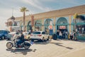 Pismo Beach pier plaza, shops and restaurants, and resting people