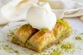 Pistachio baklava with ice cream on a white wooden background. Close up baklava Royalty Free Stock Photo