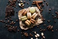 Pistachio chocolate coffee and vanilla flavored macaroons with pieces of chocolate cinnamon sticks coffee beans and pistachios Royalty Free Stock Photo