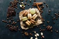 Pistachio chocolate coffee and vanilla flavored macaroons with pieces of chocolate cinnamon sticks coffee beans and pistachios Royalty Free Stock Photo