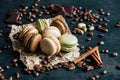 Pistachio chocolate coffee and vanilla flavored macaroons with pieces of chocolate cinnamon sticks coffee beans and pistachios Royalty Free Stock Photo