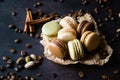 Pistachio chocolate coffee and vanilla flavored macaroons with pieces of chocolate cinnamon sticks coffee beans and pistachios Royalty Free Stock Photo