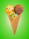 Pistachio, chocolate and vanilla ice cream balls with caramel sauce and nuts in waffle cone on a color background Royalty Free Stock Photo