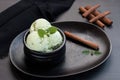 pistachio ice cream in a black waffle cone. Royalty Free Stock Photo