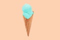 Pistachio ice cream cone on faded pastel color background. Royalty Free Stock Photo