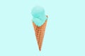 Pistachio ice cream cone on green faded pastel color background. Royalty Free Stock Photo