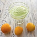 Pistachio ice cream in glass bowl and apricots Royalty Free Stock Photo