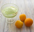 Pistachio ice cream in glass bowl and apricots Royalty Free Stock Photo