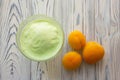 Pistachio ice cream in glass bowl and apricots on the wooden background Royalty Free Stock Photo