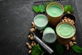 Pistachio ice cream with mint and pistachios. Ice cream spoon. On a black stone background Royalty Free Stock Photo