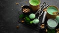 Pistachio ice cream with mint and pistachios. Ice cream spoon. On a black stone background Royalty Free Stock Photo
