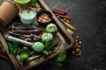 Pistachio ice cream with mint and pistachios. Ice cream spoon. On a black stone background Royalty Free Stock Photo