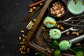 Pistachio ice cream with mint and pistachios. Ice cream spoon. On a black stone background, Royalty Free Stock Photo