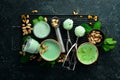 Pistachio ice cream with mint and pistachios. Ice cream spoon. On a black stone background Royalty Free Stock Photo