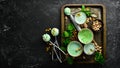 Pistachio ice cream with mint and pistachios. Ice cream spoon. On a black stone background, Royalty Free Stock Photo