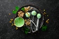 Pistachio ice cream with mint and pistachios. Ice cream spoon. On a black stone background Royalty Free Stock Photo