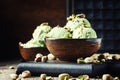 Pistachio ice cream with nuts, decorated with mint leaves, vintage wooden background, selective focus Royalty Free Stock Photo