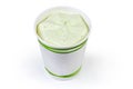 Pistachio ice cream in paper cup on a white background Royalty Free Stock Photo