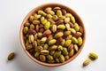 Pistachio nuts in a bowl isolated on white background. Generative AI Royalty Free Stock Photo