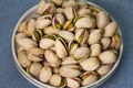 Pistachio in a plate isolate on blue background Royalty Free Stock Photo