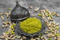 Pistachio powder on dark background. It`s surrounded by pistachios. close-up Royalty Free Stock Photo