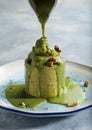 Pistachio volcano cake served in a dish side view isolared on wooden table