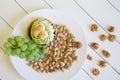 Pistachios, a bunch of grapes, cake and walnuts on white boards. Country breakfast Royalty Free Stock Photo