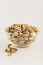 Pistachios in a glass bowl on a light background