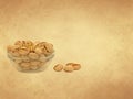 Pistachios in a glass bowl on old paper background