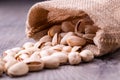 Pistachios nut in burlap sack on grained wood background Royalty Free Stock Photo