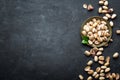 Pistachios nuts on dark background, top view, healthy snack