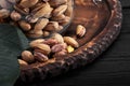 Pistachios nuts on dark background, top view, healthy snack Royalty Free Stock Photo