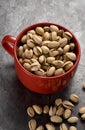 Pistachios in a Red Cup on Granite Counter