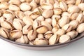 Pistachios in their shells, roasted and salted, in a brown bowl, front view Royalty Free Stock Photo