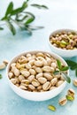 Pistachios. Whole pistachios with green leaves and pistachio nut kernels Royalty Free Stock Photo