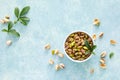 Pistachios. Whole pistachios with green leaves and pistachio nut kernels. Healthy natural vegetarian organic food Royalty Free Stock Photo