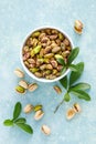 Pistachios. Whole pistachios with green leaves and pistachio nut kernels Royalty Free Stock Photo